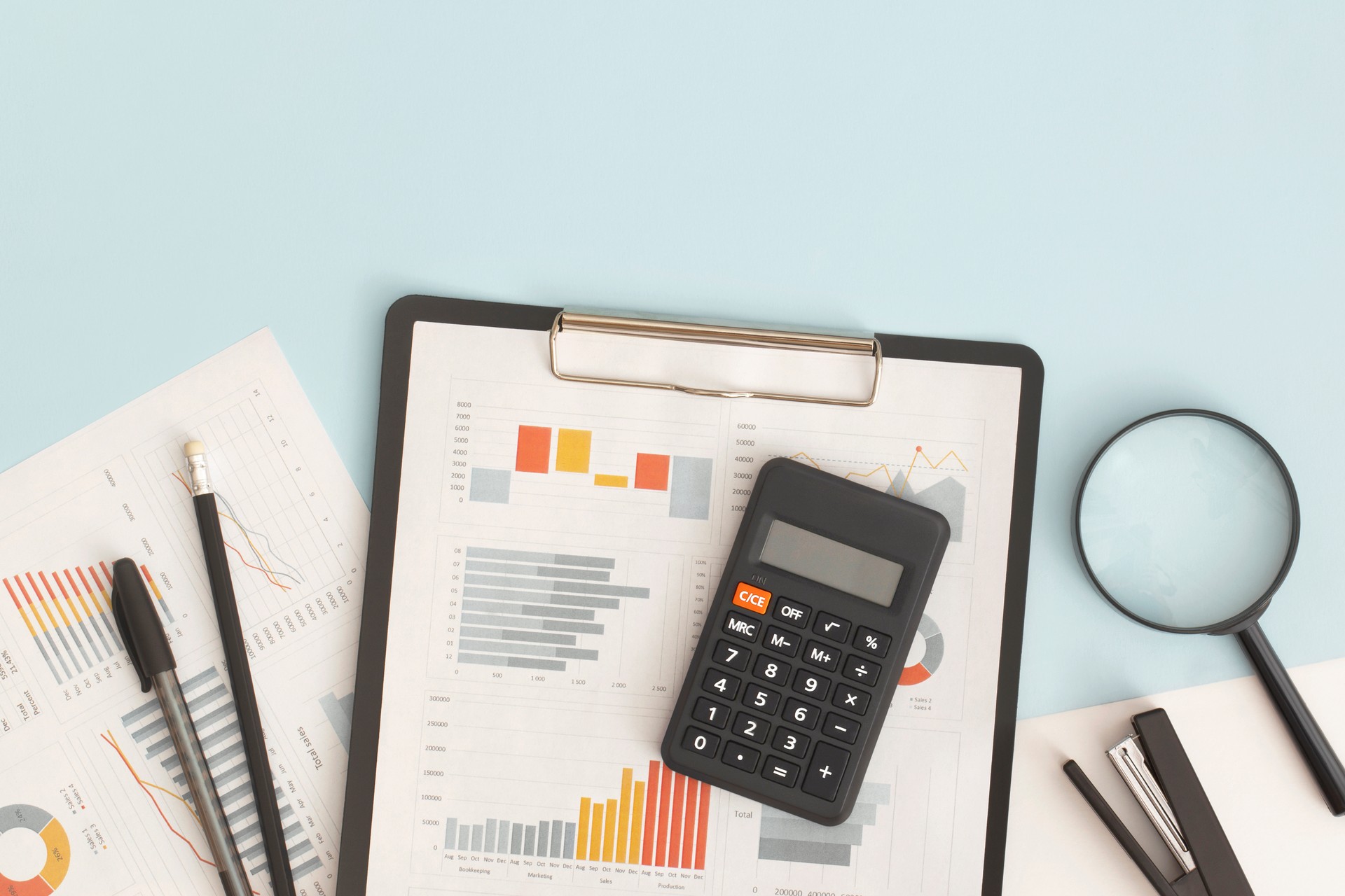 Business graphs, charts, magnifying glass and calculator on table. Financial development, Banking Account, Statistics