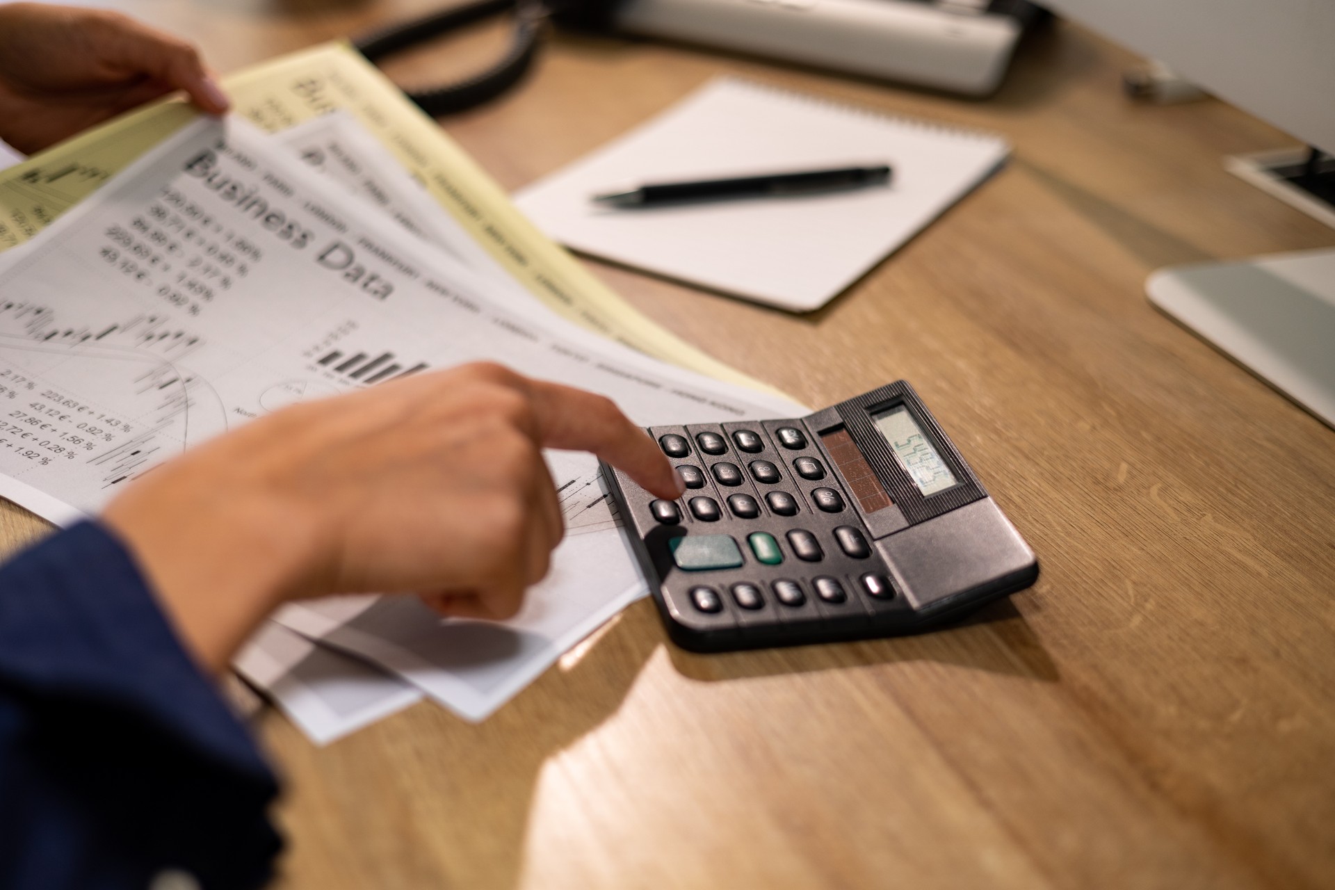 File clerk types on a calculator, close up woman's hand in the business office.